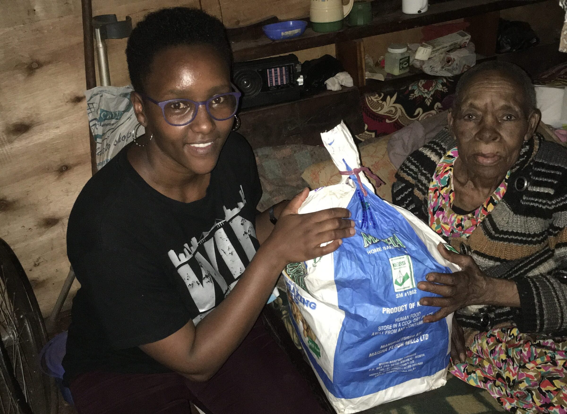 Mary Wairimu receiving her monthly food package